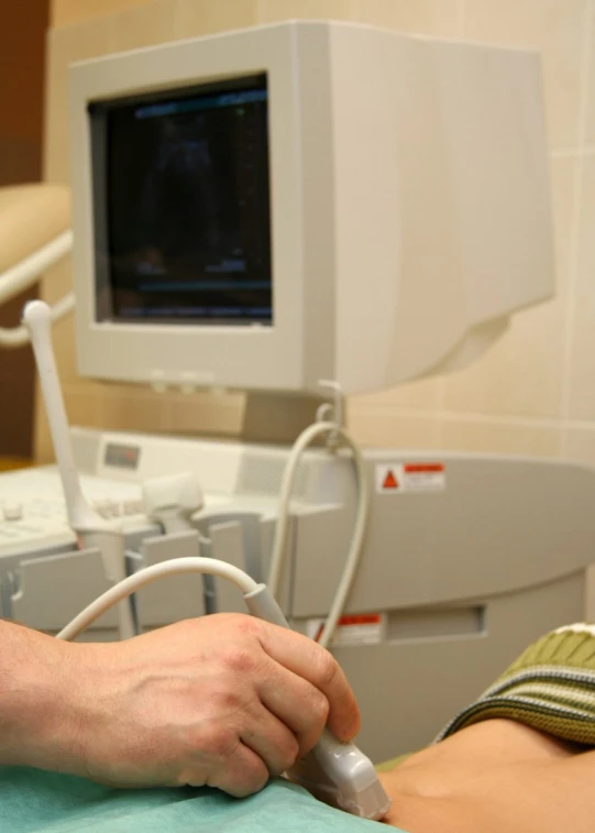 two hands holding soing to someone in an operating room