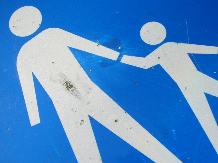 a blue and white pedestrian sign with two people crossing