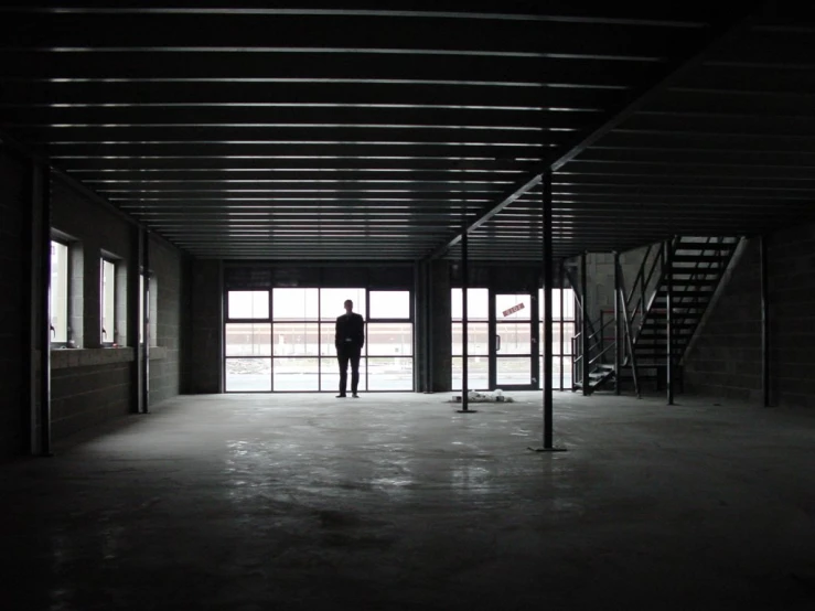 a person is standing in the middle of a empty building