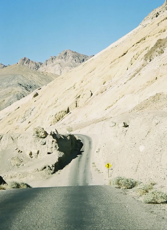 a mountain road is shown with mountains in the background