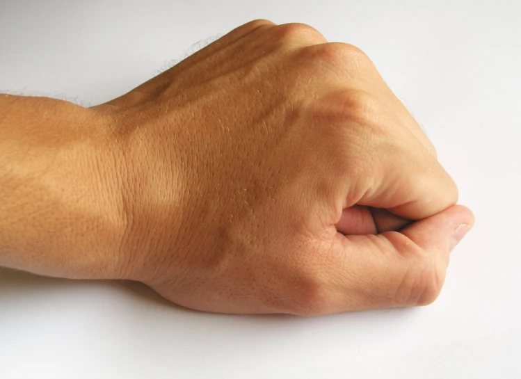 a person holding their arm with a ring on the wrist