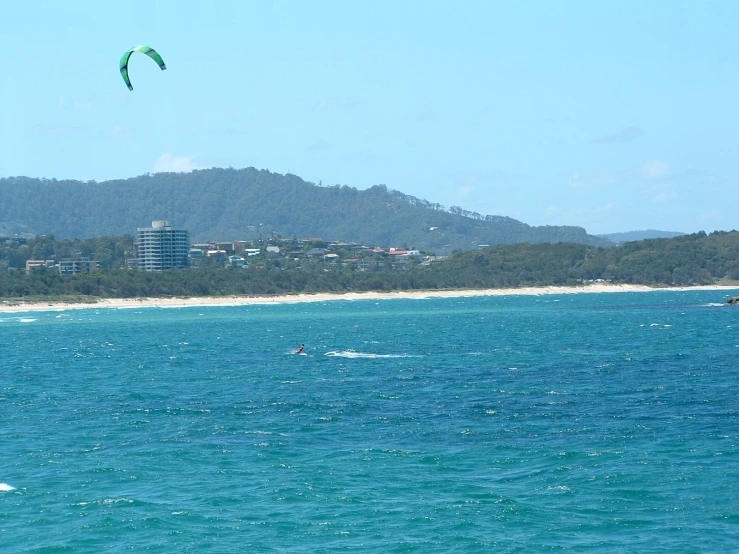 a surfer is in the ocean holding onto his sails