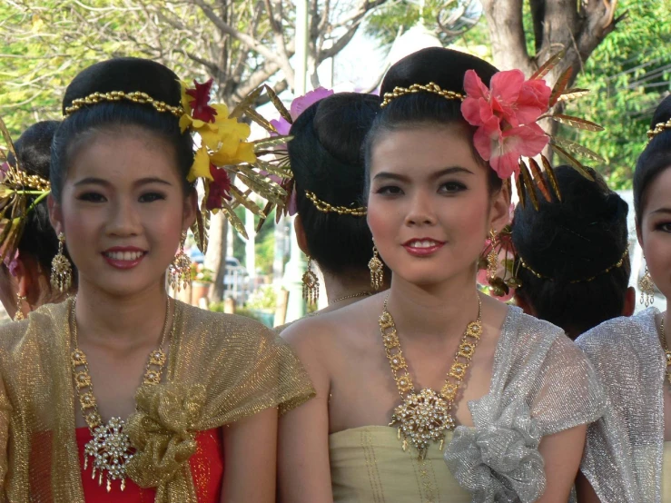 several beautiful young ladies dressed in formal wear