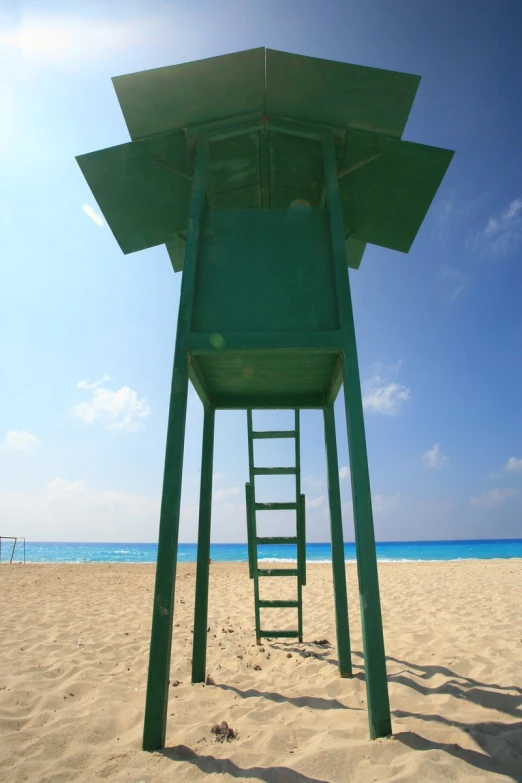 a tall chair that is sitting on top of a beach