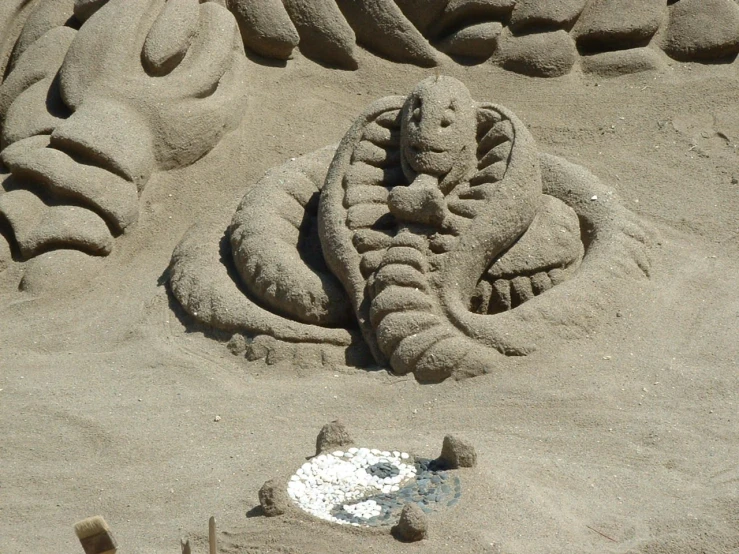 a sand sculpture of an elephant made of human like materials