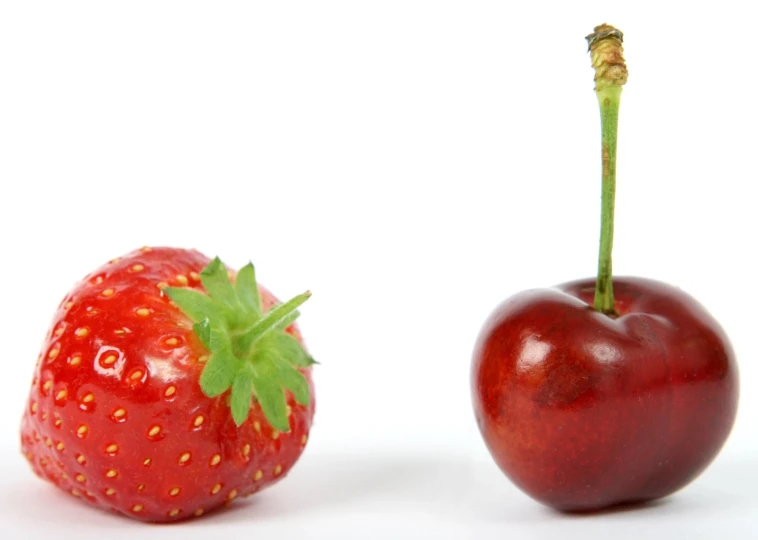 two different fruits on a white background one with a strawberry