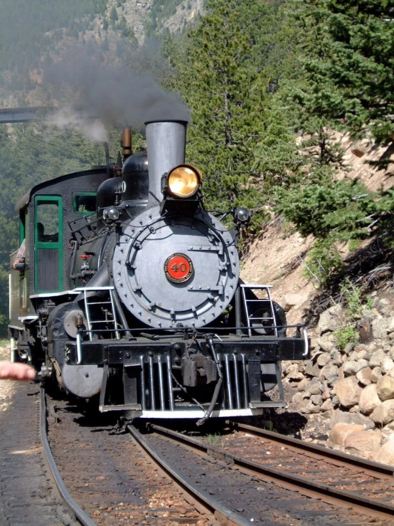 a vintage steam locomotive is moving along tracks