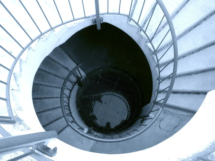 an industrial looking spiral staircase in black and white