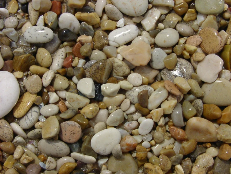 many different rocks, pebbles and stones all grouped together