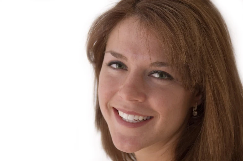 a woman is smiling with a white background