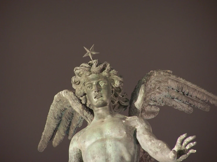 a statue of an angel holding a bird