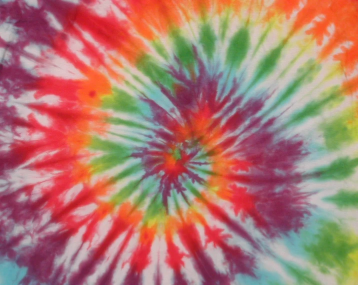 a multicolored tie - dye background is shown