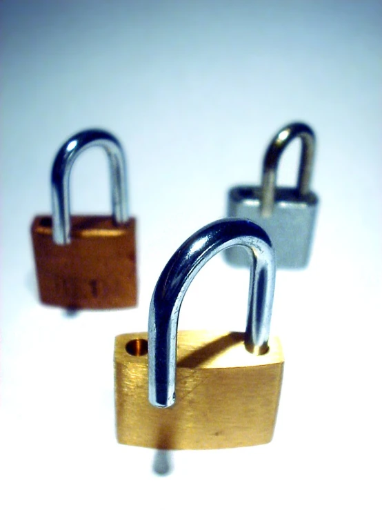 two metal padlocks with a single lock