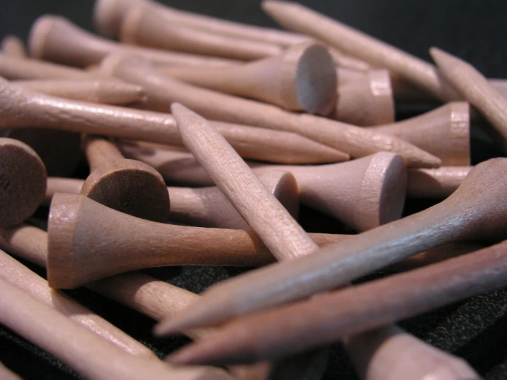 a pile of wooden dowks sitting on top of a black surface