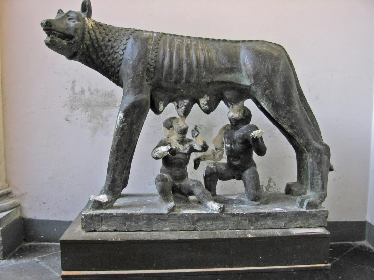 statue with people dancing around an animal standing