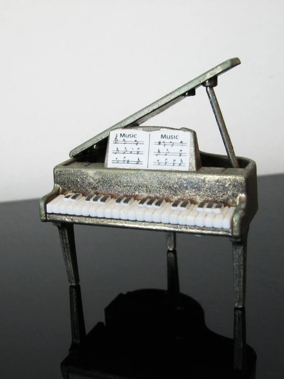 an empty metal musical keyboard resting on a dark surface
