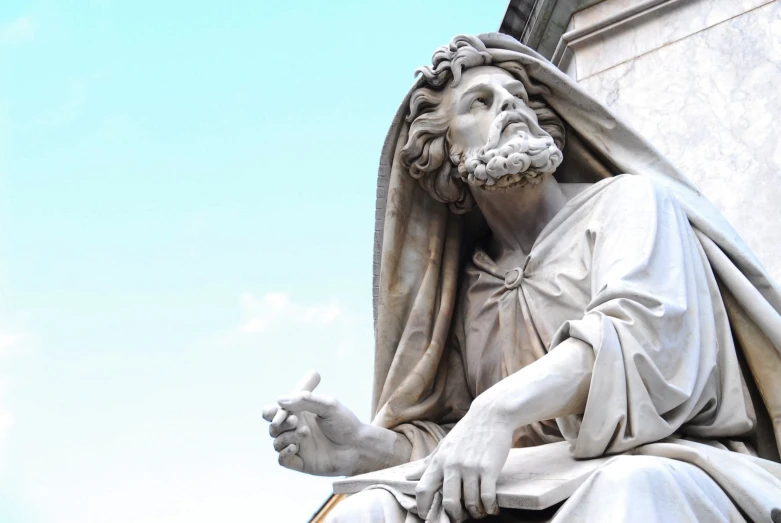 statue of a jesus outside next to some building