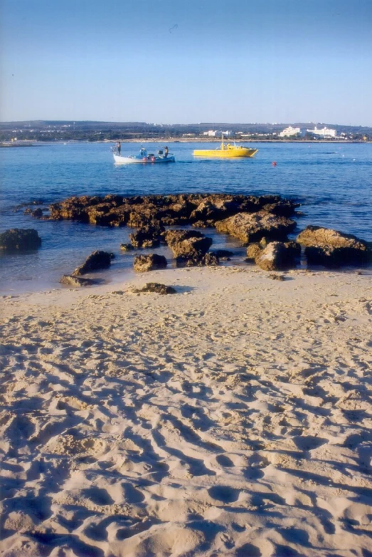 an ocean view of boats and a beach