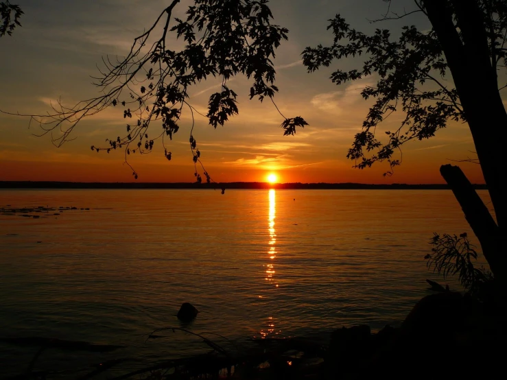 the sun rises in the distance as the boat is out