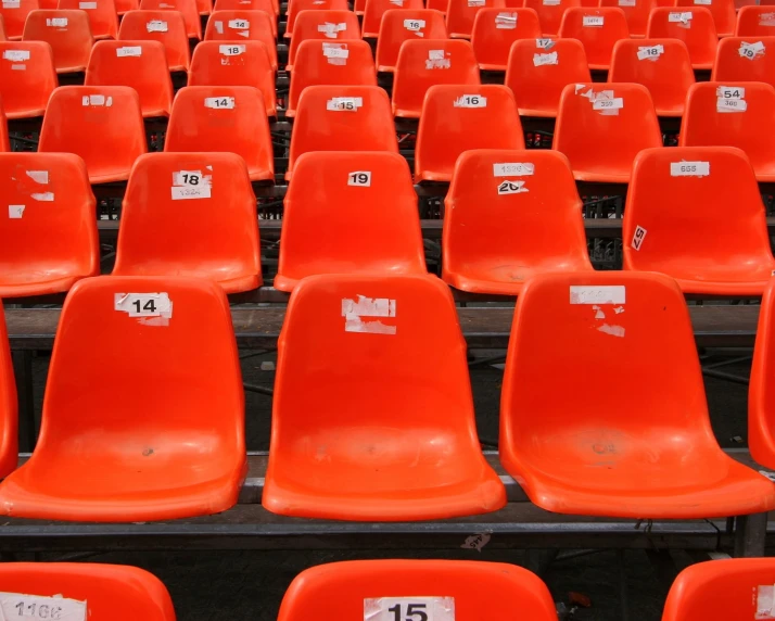 rows of orange seats with numbered labels on them