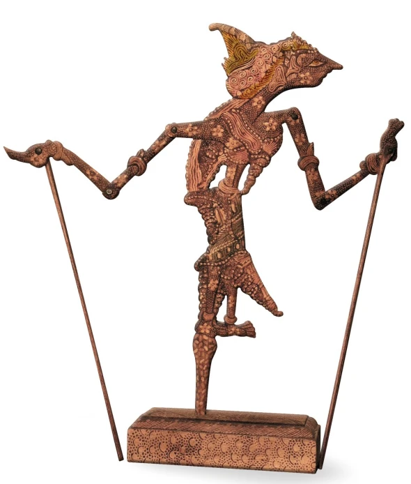 a wooden statue with two long poles in the shape of a dancing woman