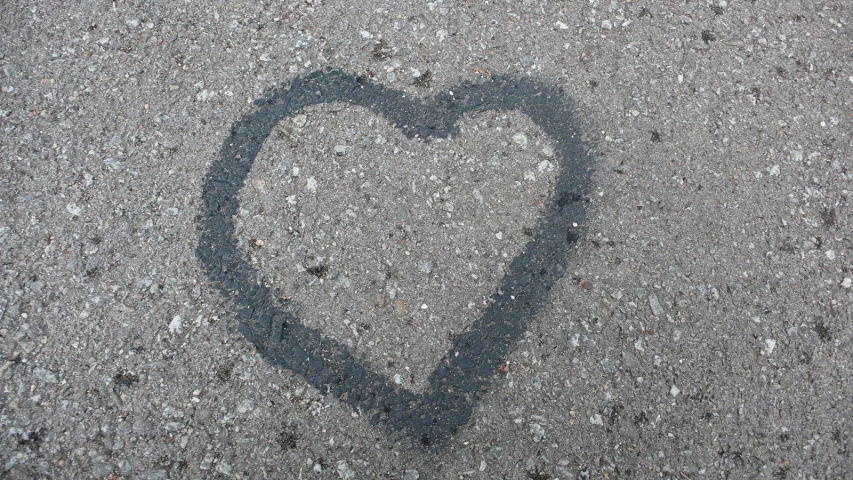 an image of a heart drawn on asphalt