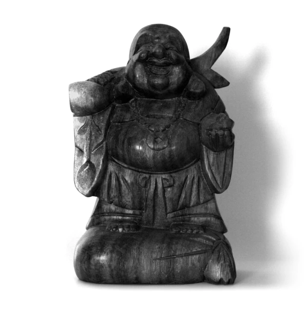 a statue of a smiling buddha sitting in a pose