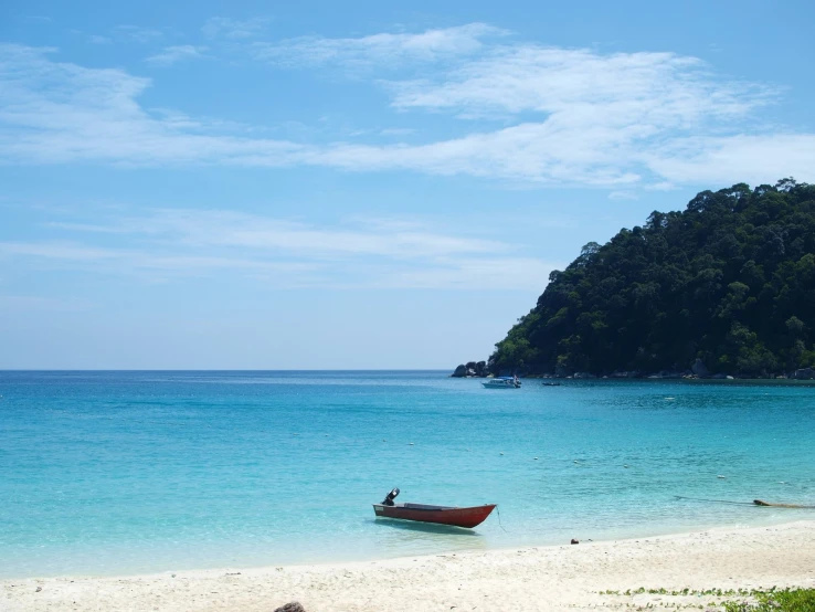 a small boat floating on top of a large body of water