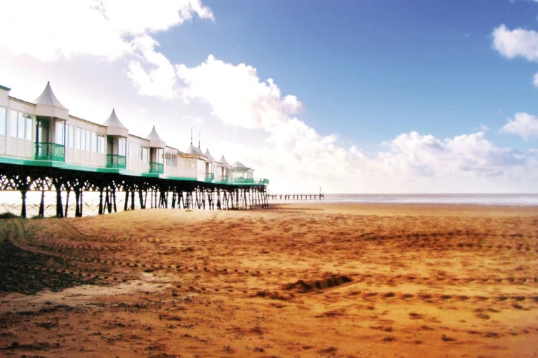 several pier with buildings and sand on the beach