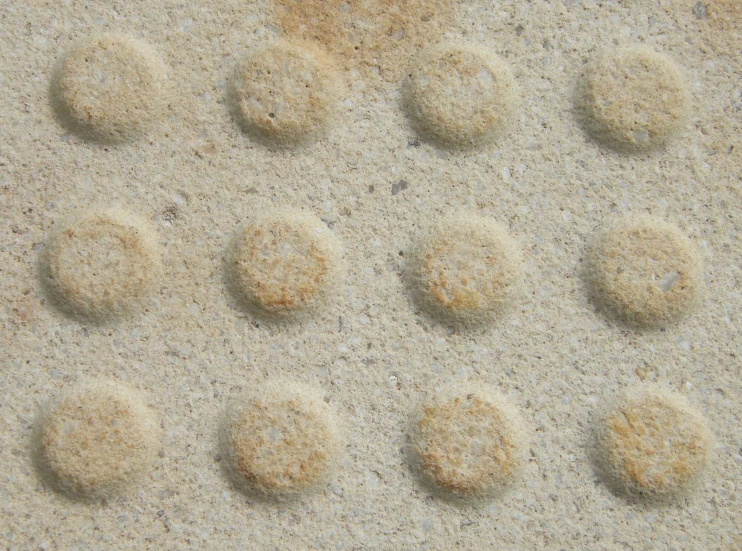 some type of bubbles are next to a sand dune