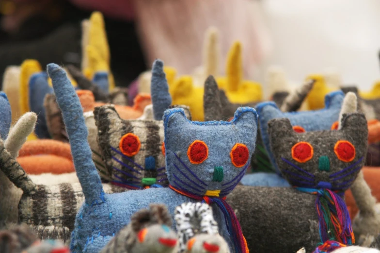 small cloth toy cats made to look like the head of cats