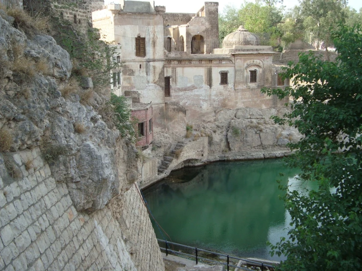 a castle is near some water and rocks