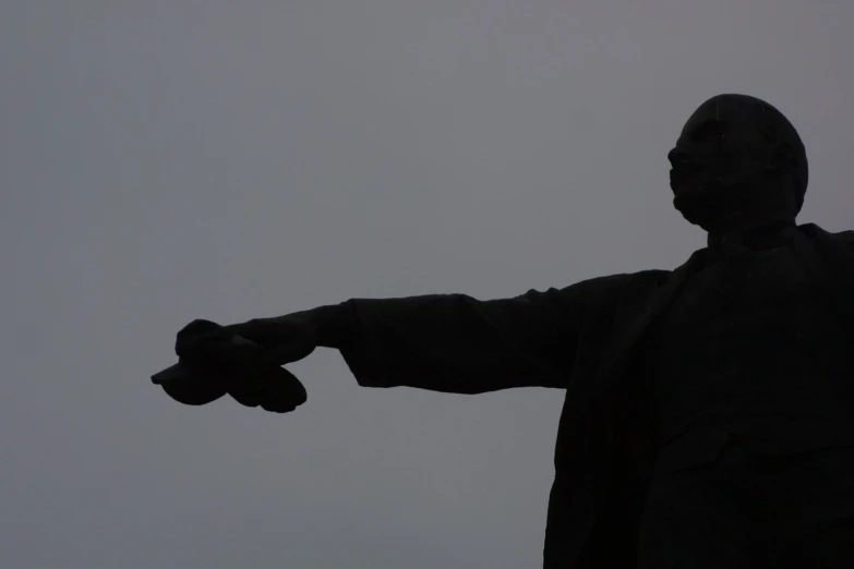 statue of man with outstretched arms in the fog