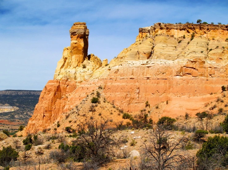 a mountain range with rocks and trees at the base