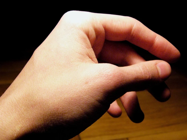 a person's hand, with one finger pointing upwards