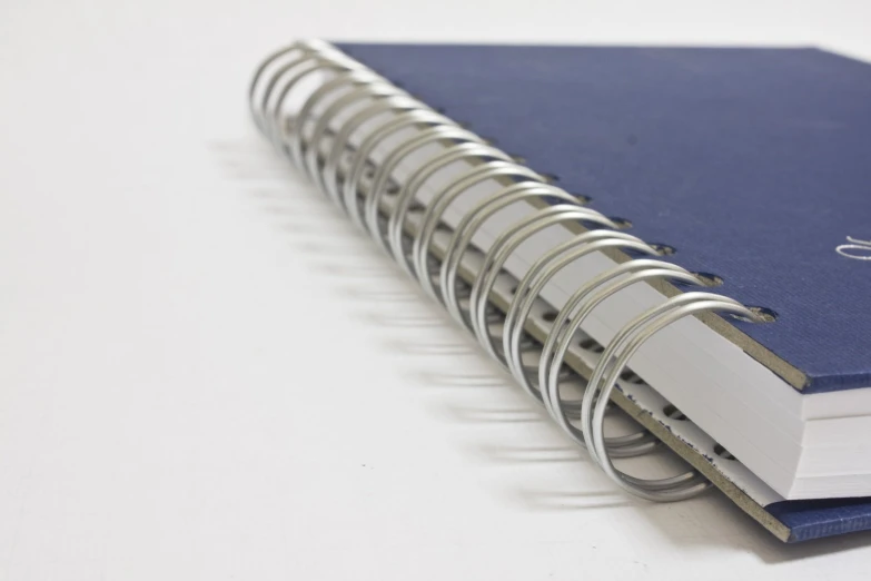 a blue notebook on top of a white table