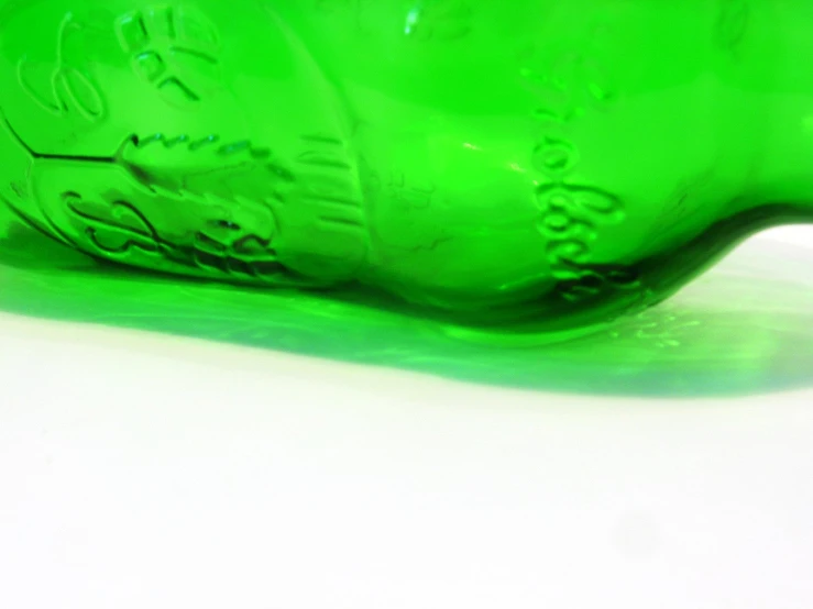 a green plastic bottle with writing on it