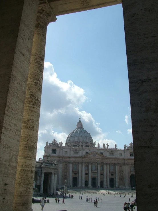 view through archway of a building with dome of church