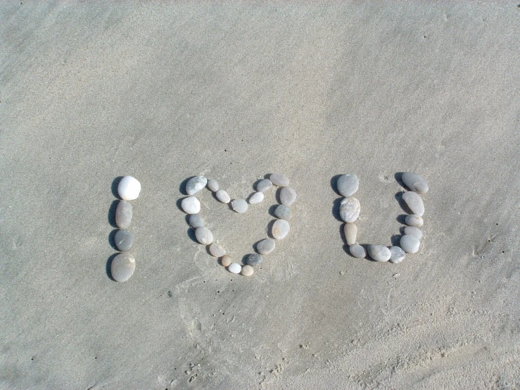 a close up of rocks on the sand