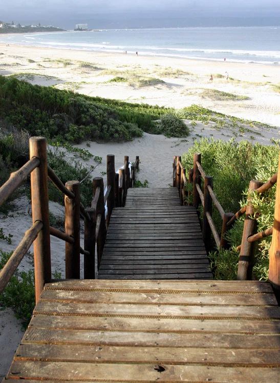 a small staircase leads up to a beach