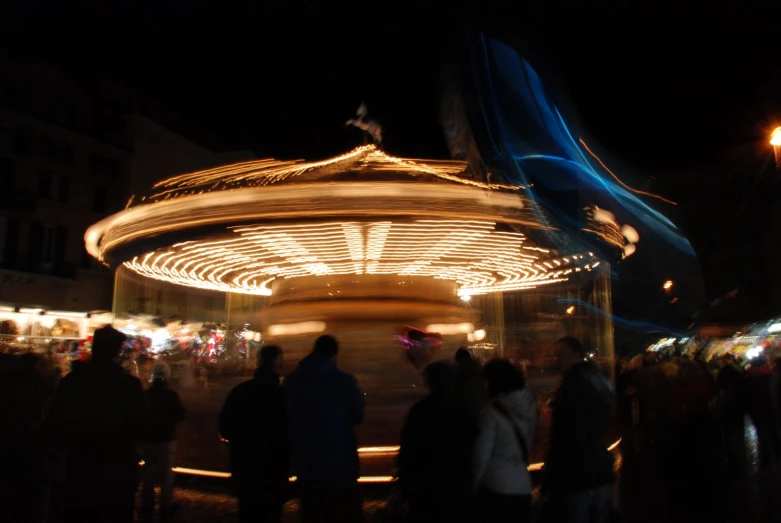 many people are walking around on a carousel