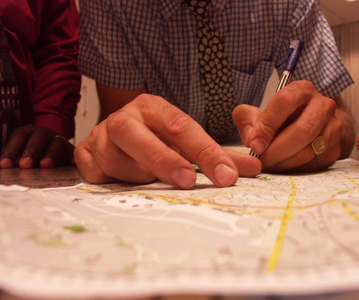 a person working on a map with a pen