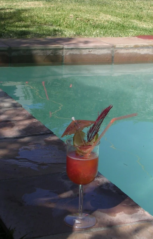 this is a close up of a drink in a glass near the water