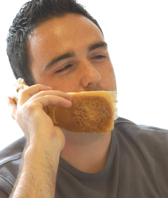 a man holds his left hand up to his mouth and eats