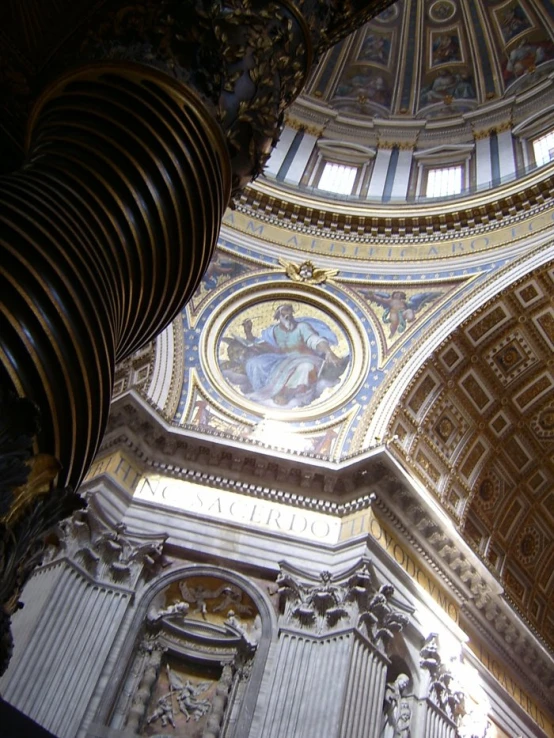 an ornate ceiling in a cathedral with a mural above it