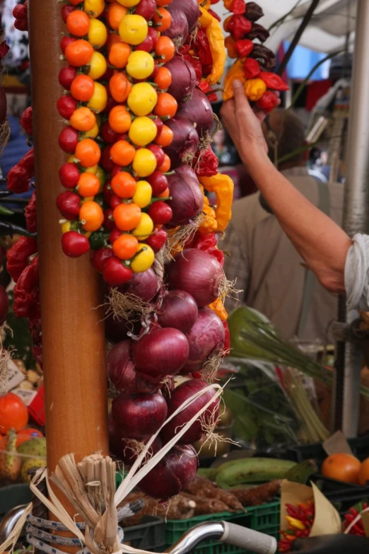 a large number of fruit on display on poles