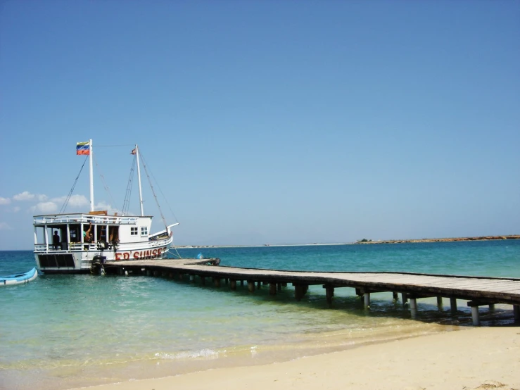 a boat is docked at a long pier