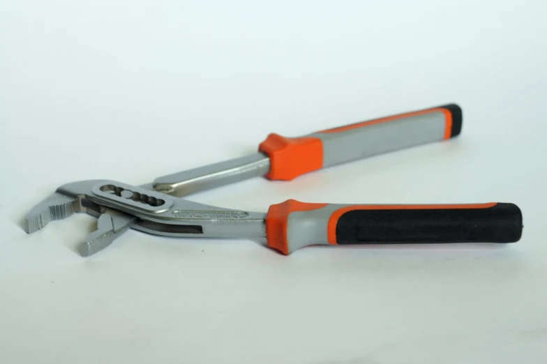 a pair of pliers are open with red handles