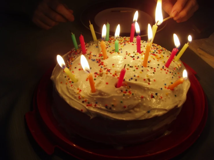 a cake with candles lit in to it