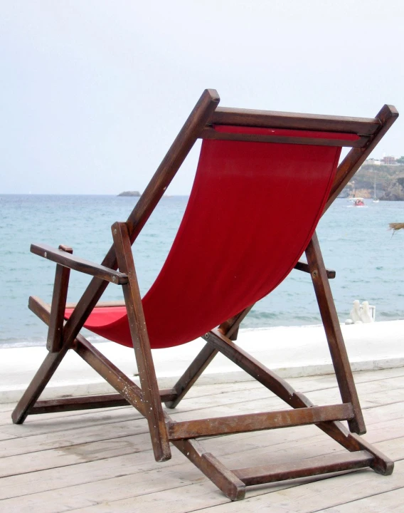 an outdoor wooden deck chair overlooking the ocean
